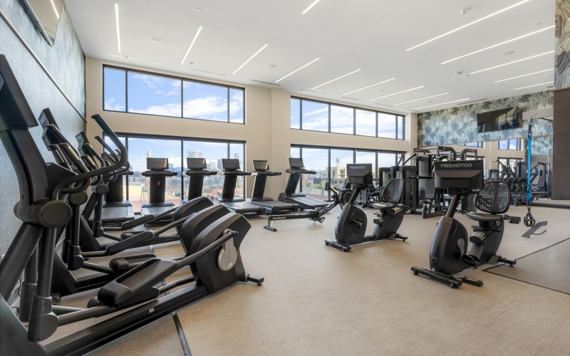 24-hour fitness center with floor-to-ceiling windows and downtown Denver views from Skyline at Highlands