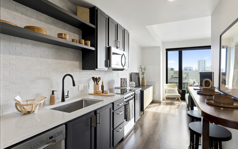 Studio apartment at Skyline at Highlands with large panorama window and wood-style flooring