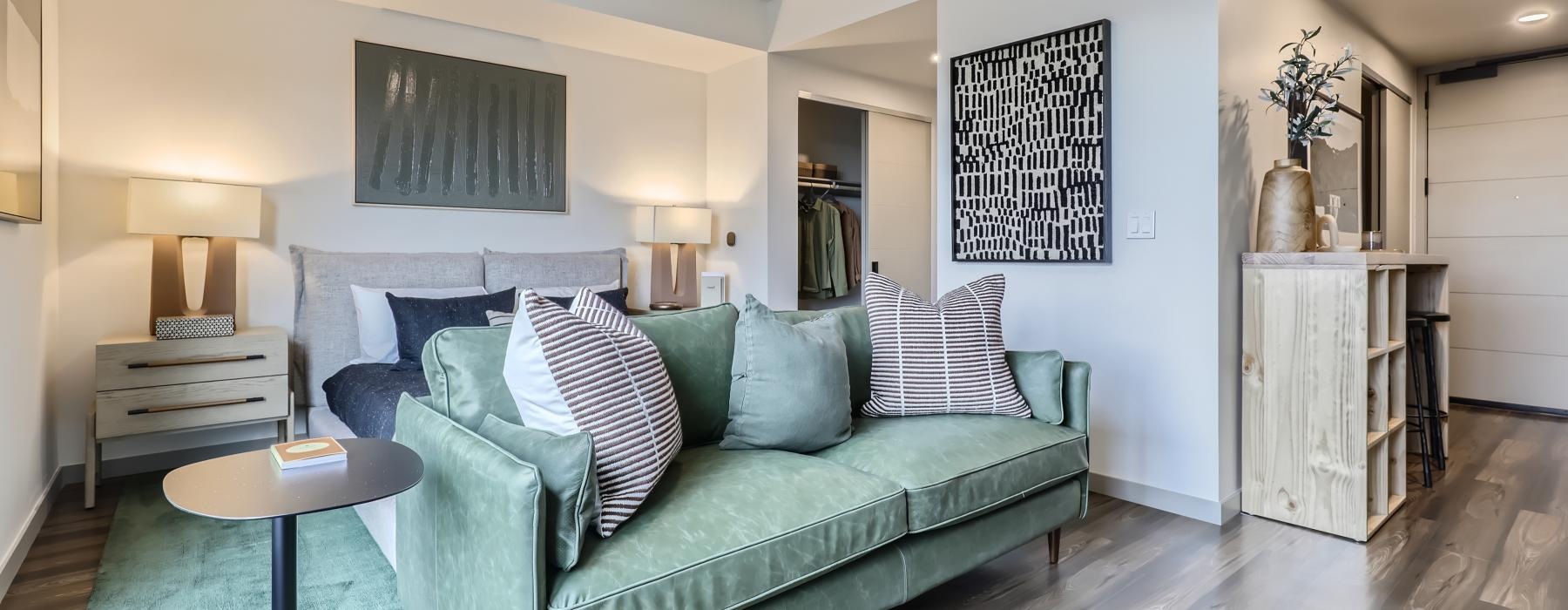 a living room with a couch and a fan