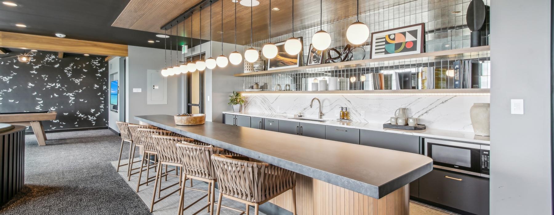 a kitchen with a bar and chairs